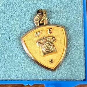 Gold Shield Pendant with Telephone Design
